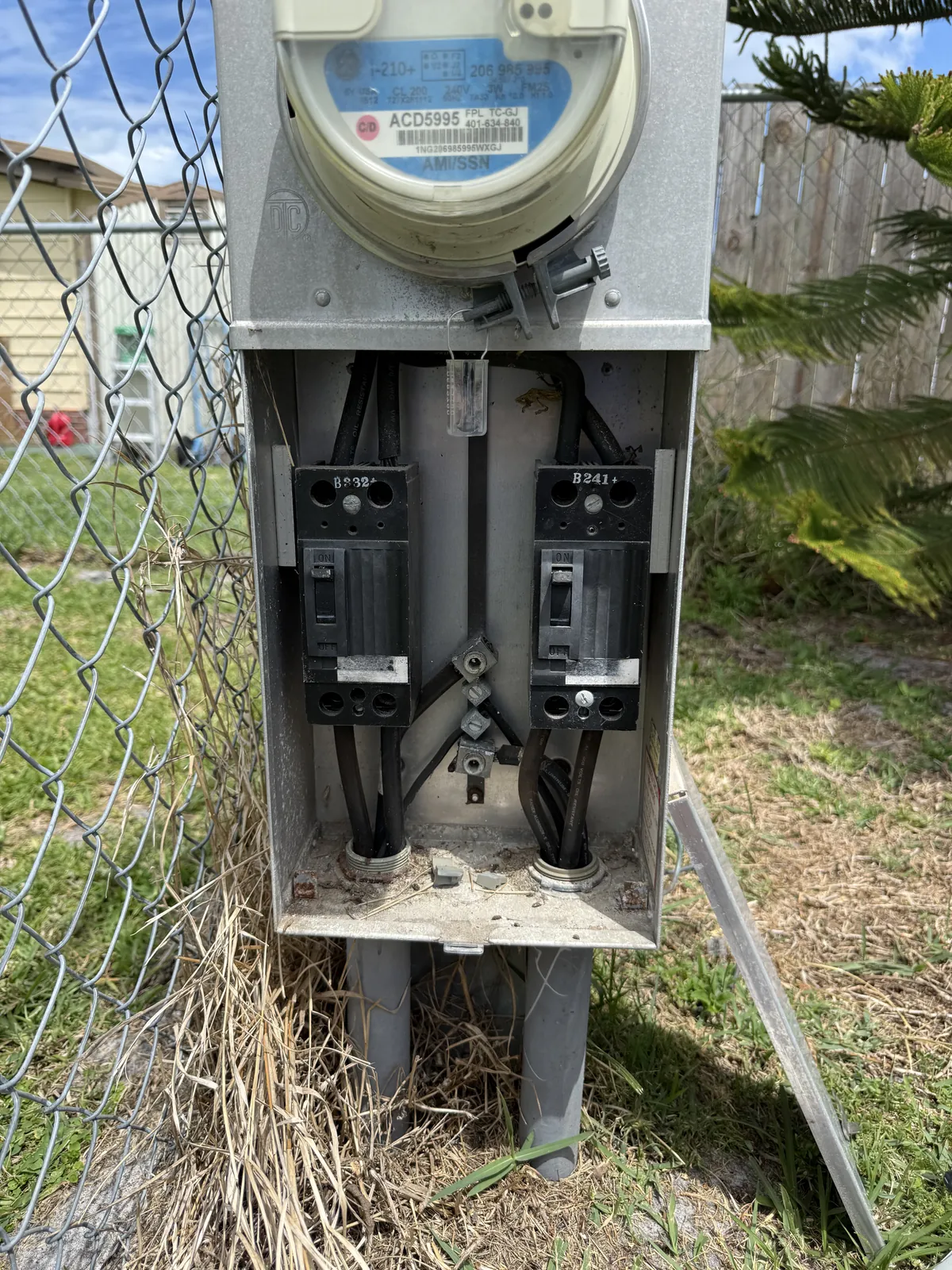 Corroded meter enclosure with rust through the base pan